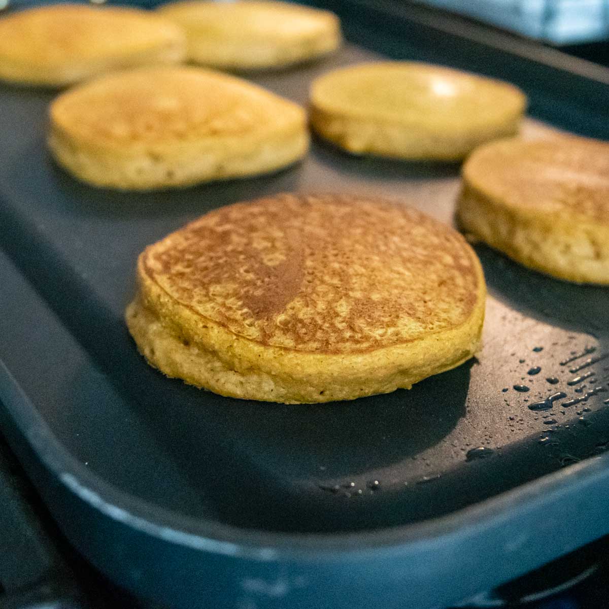 cooked pancakes on a griddle.