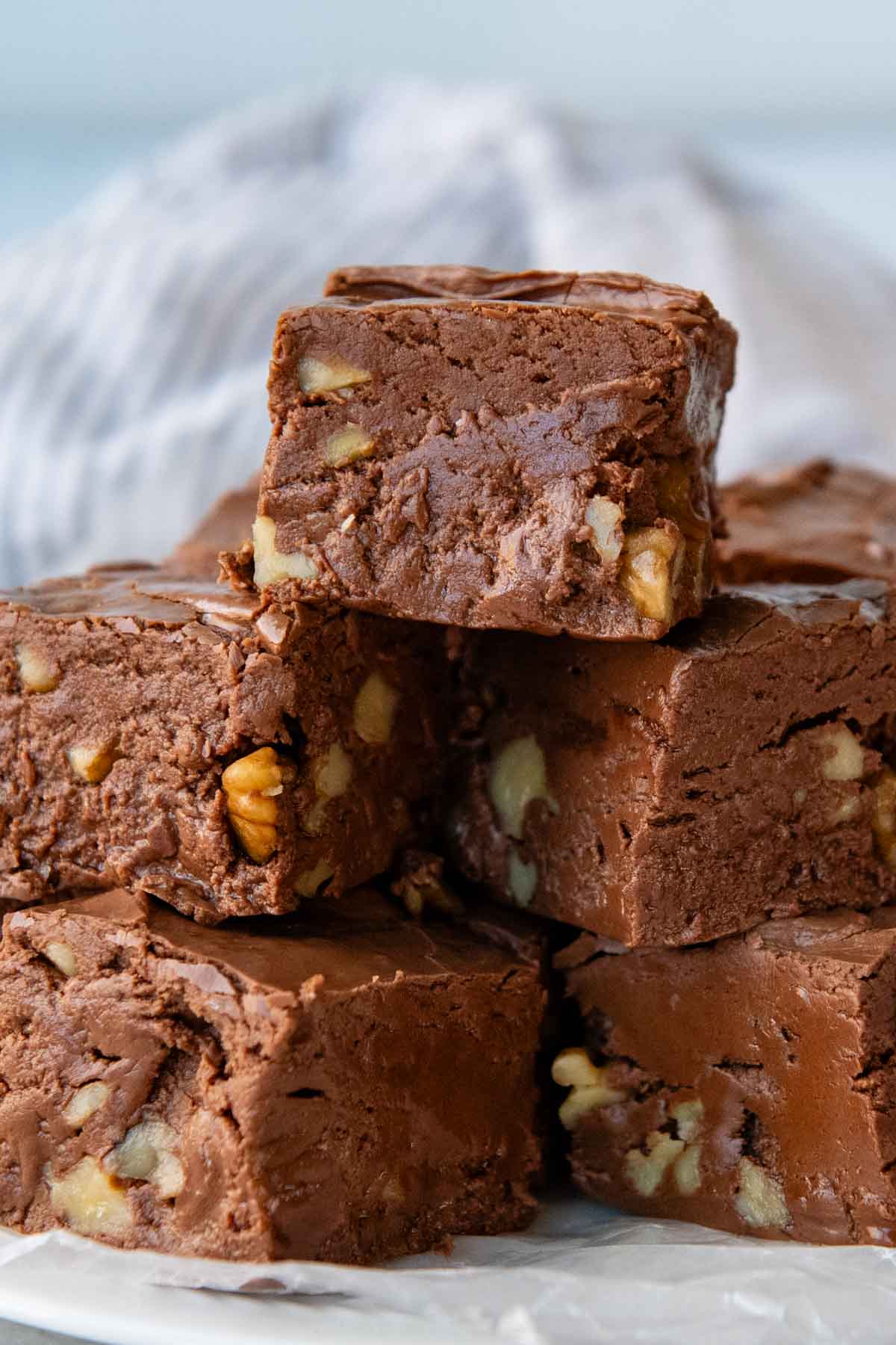 a stack of chocolate fudge with nuts inside.