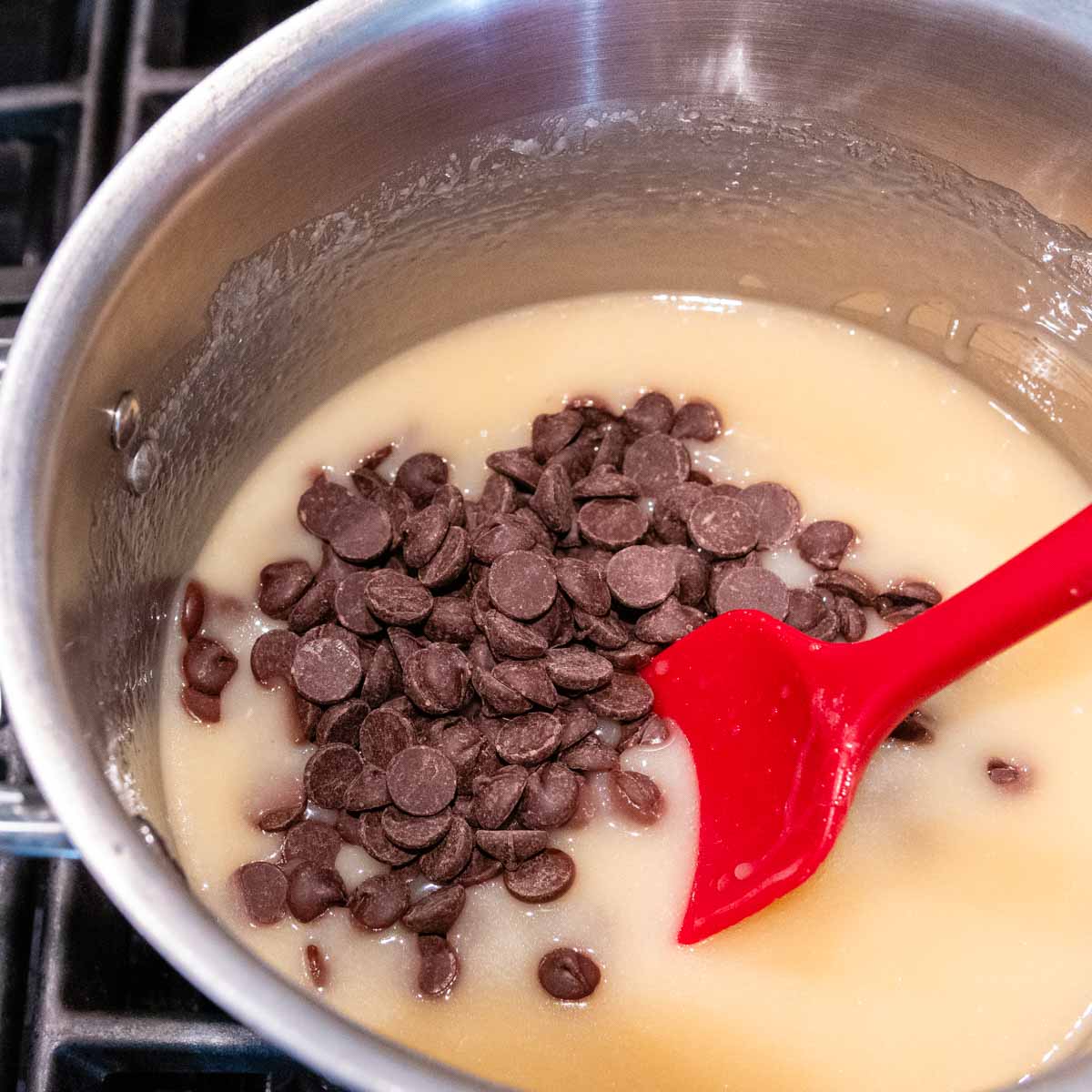 chocolate chips being stirred into milk mixture.