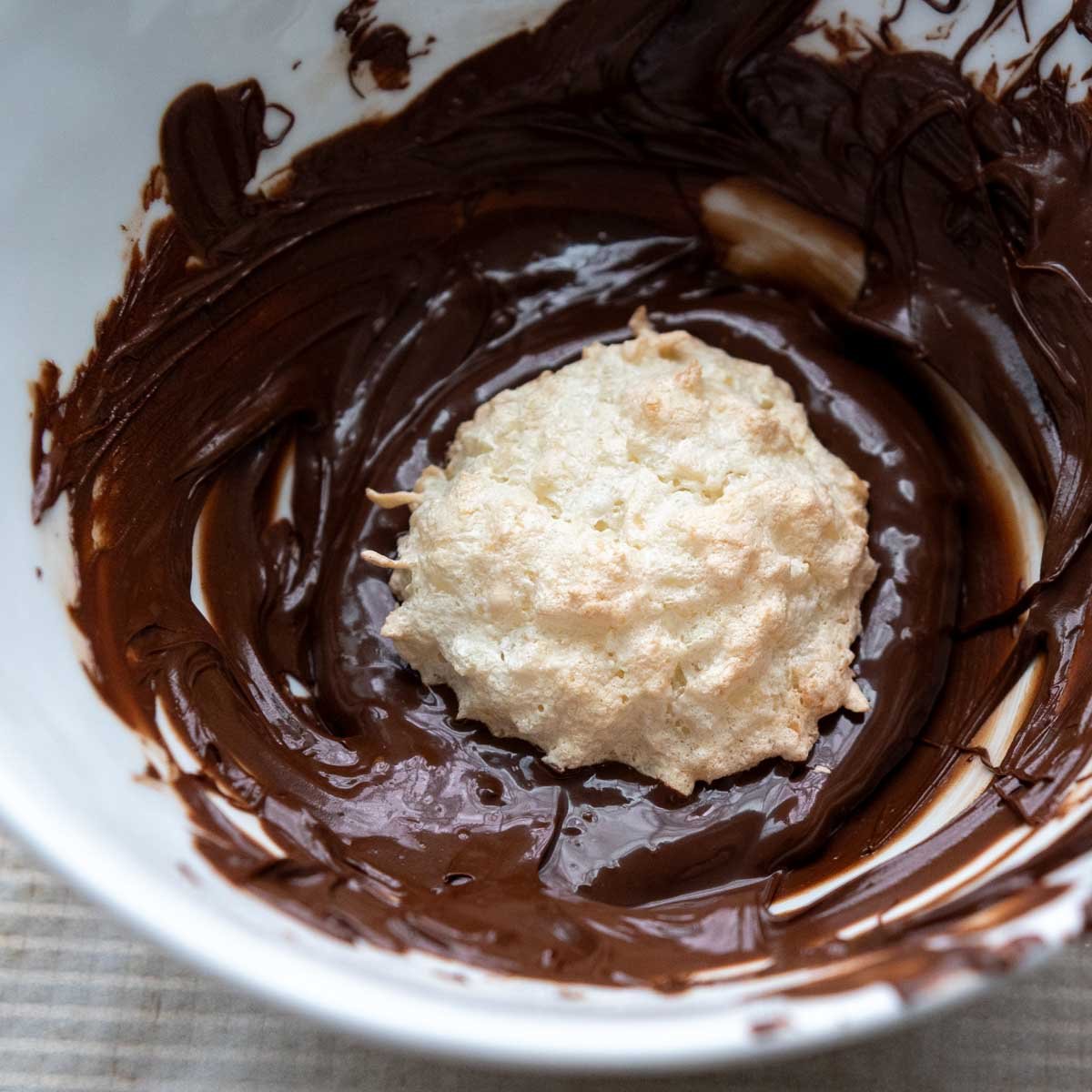 macaroon in a bowl of chocolate.