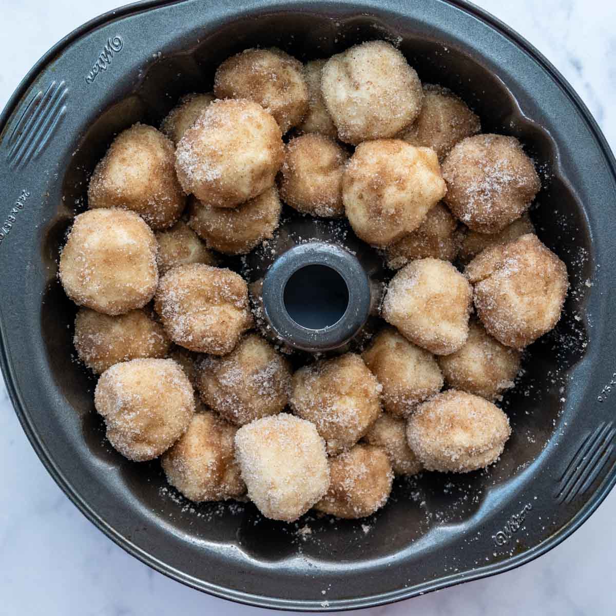 unbaked cinnamon balls in a bundt cake pan.