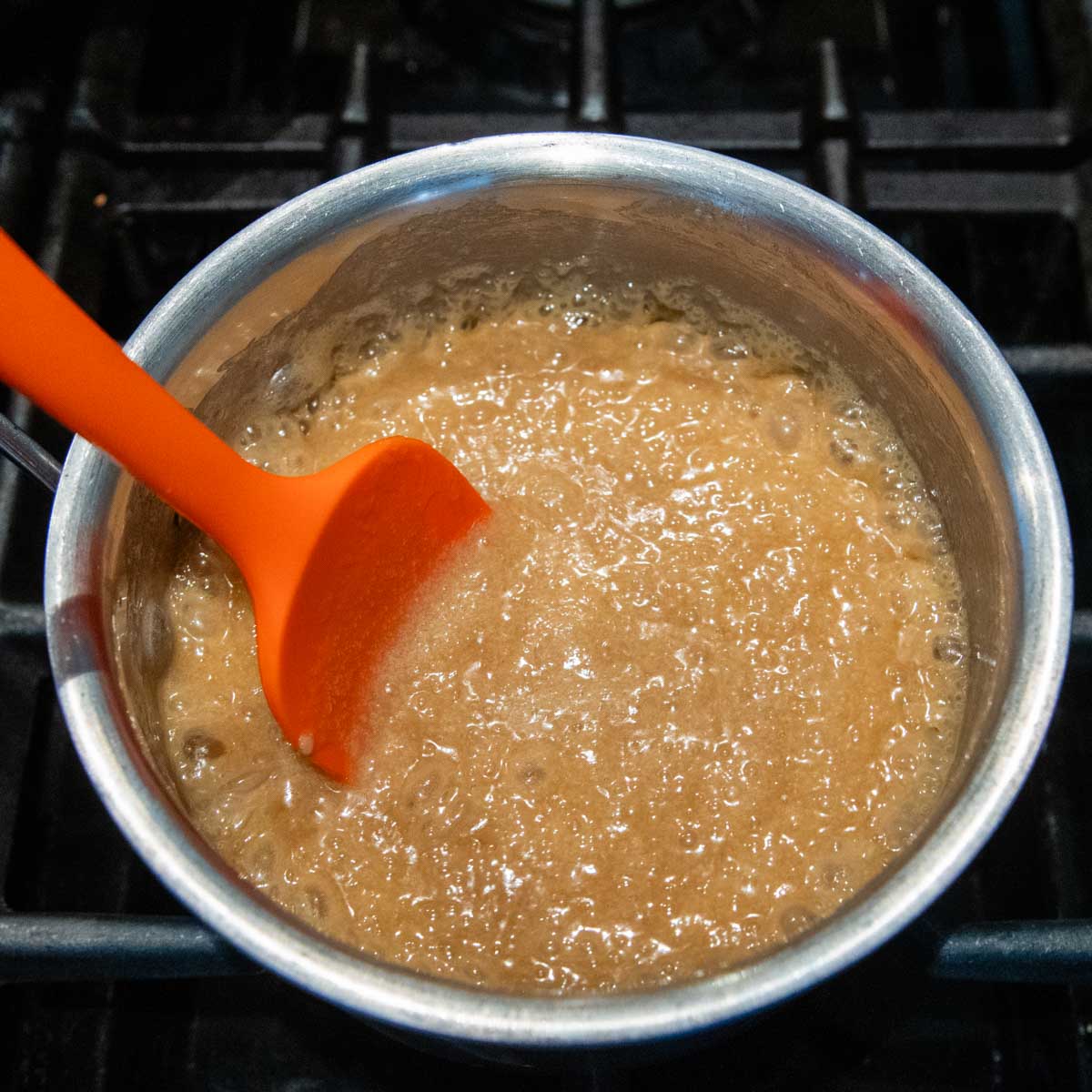 caramel sauce boiling in a saucepan.