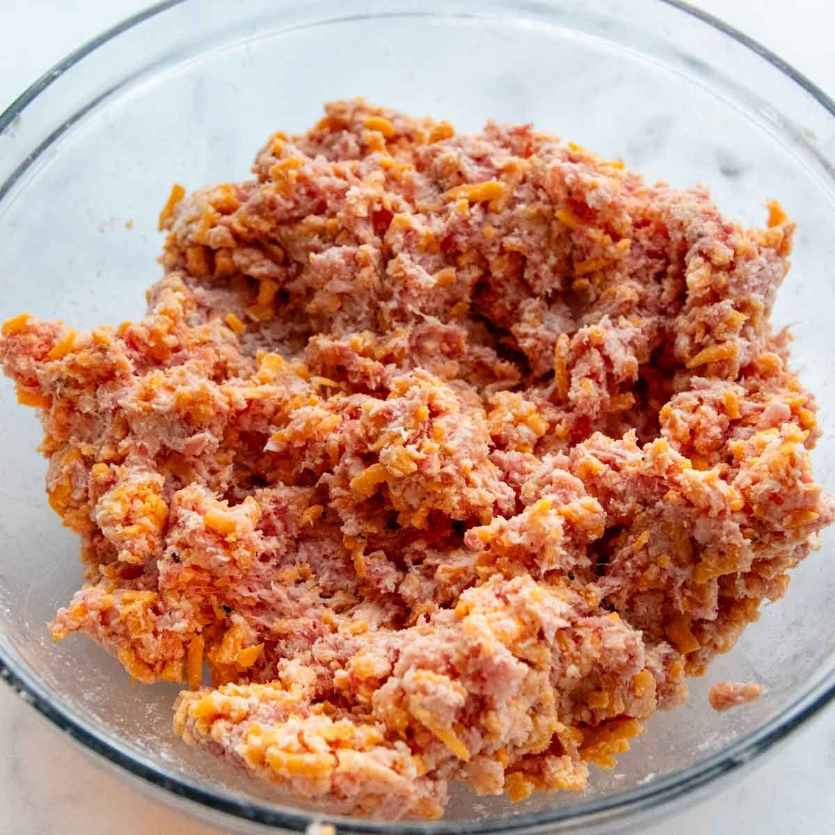 ground sausage mixture in a glass bowl.