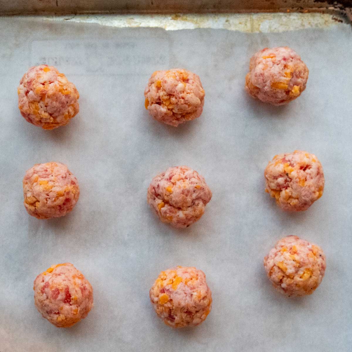 The balls shaped on a baking sheet.