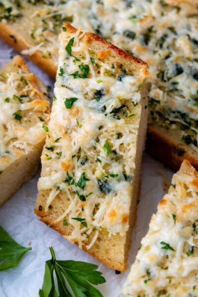 a slice of garlic bread resting on other slices.