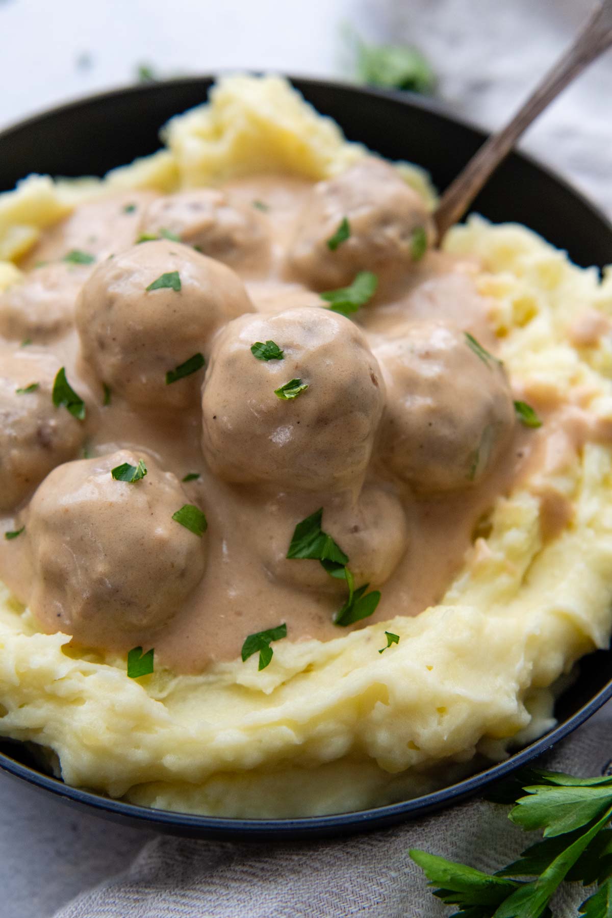 a serving of Swedish meatballs over mashed potatoes.