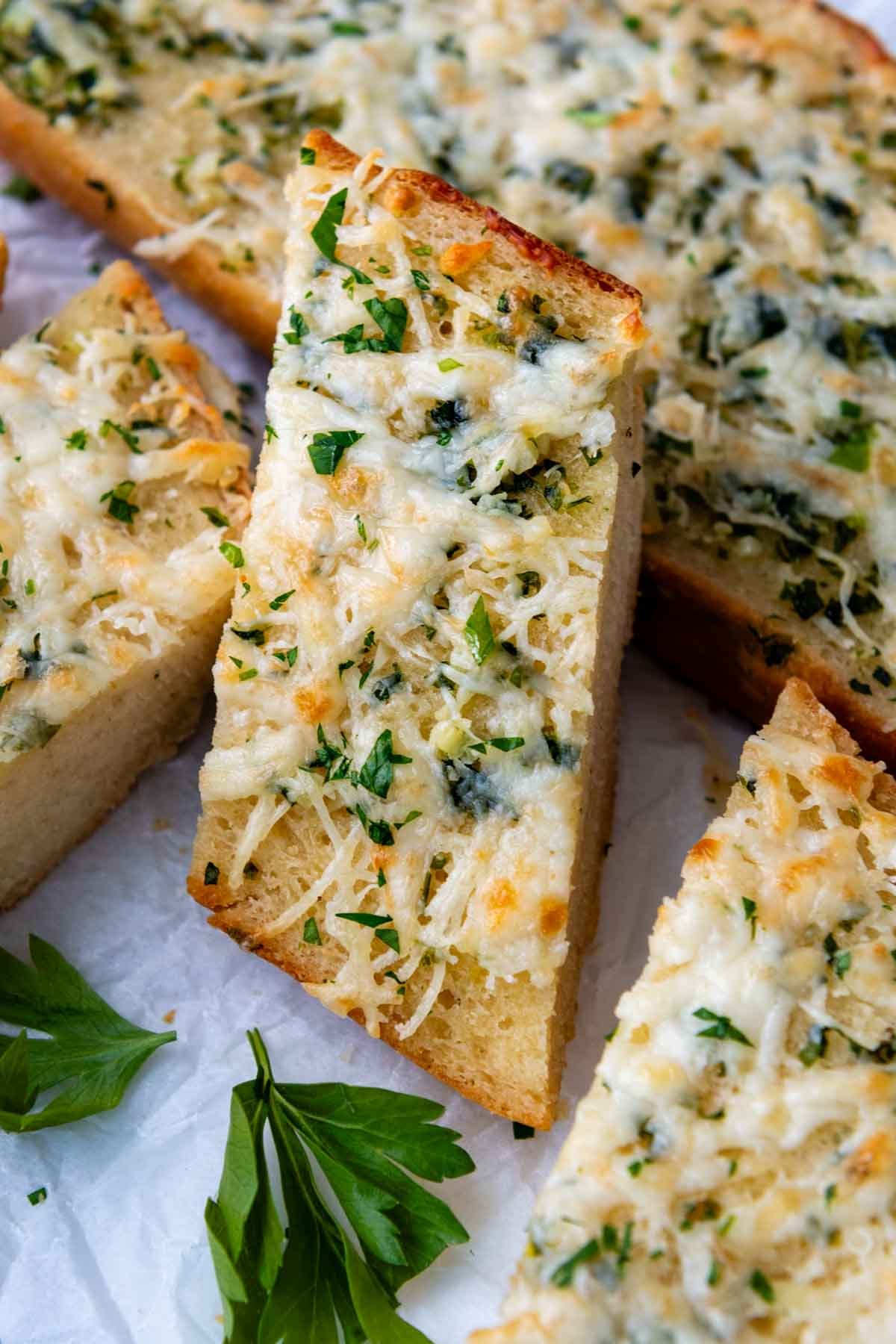 a slice of garlic bread resting on other slices.