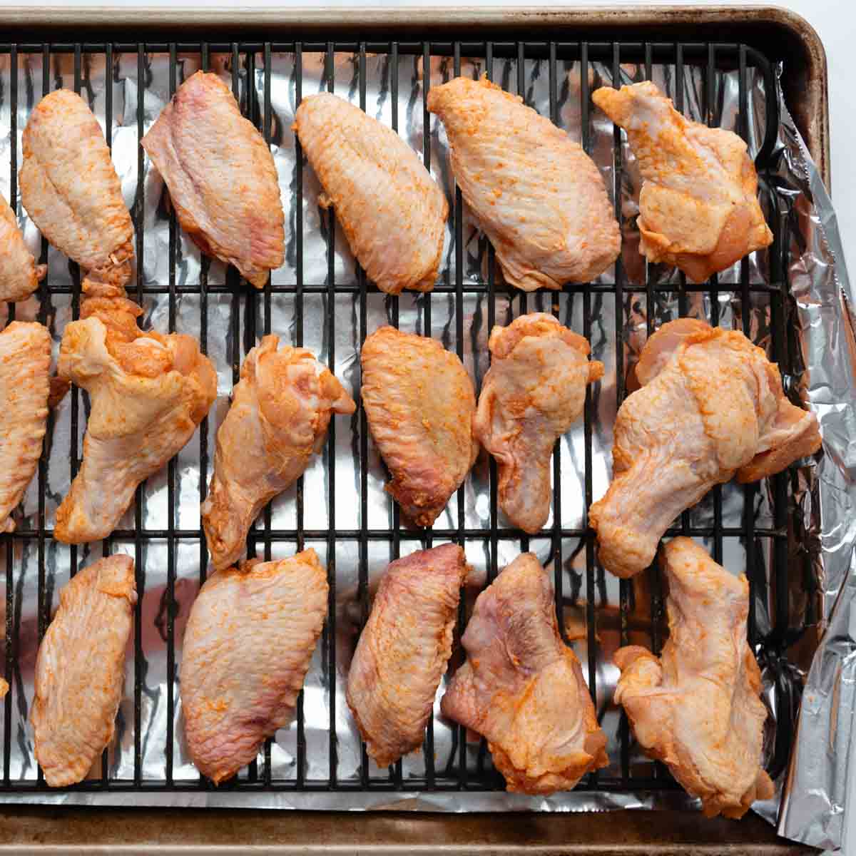 wings and drumettes arranged on a baking sheet.