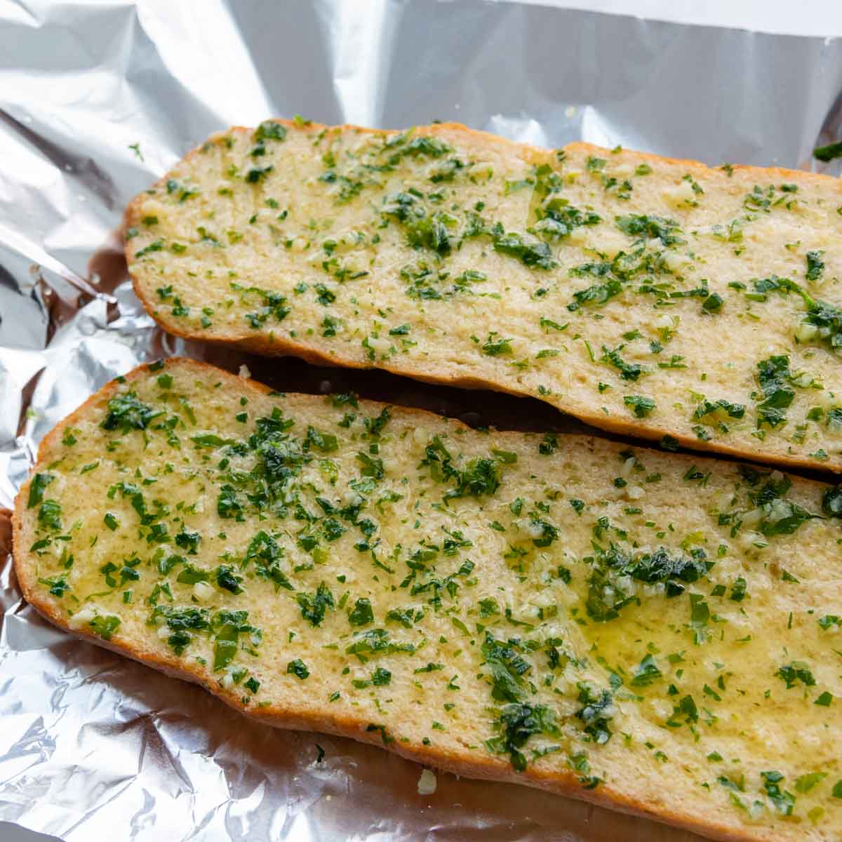 garlic butter spread on two bread halves.