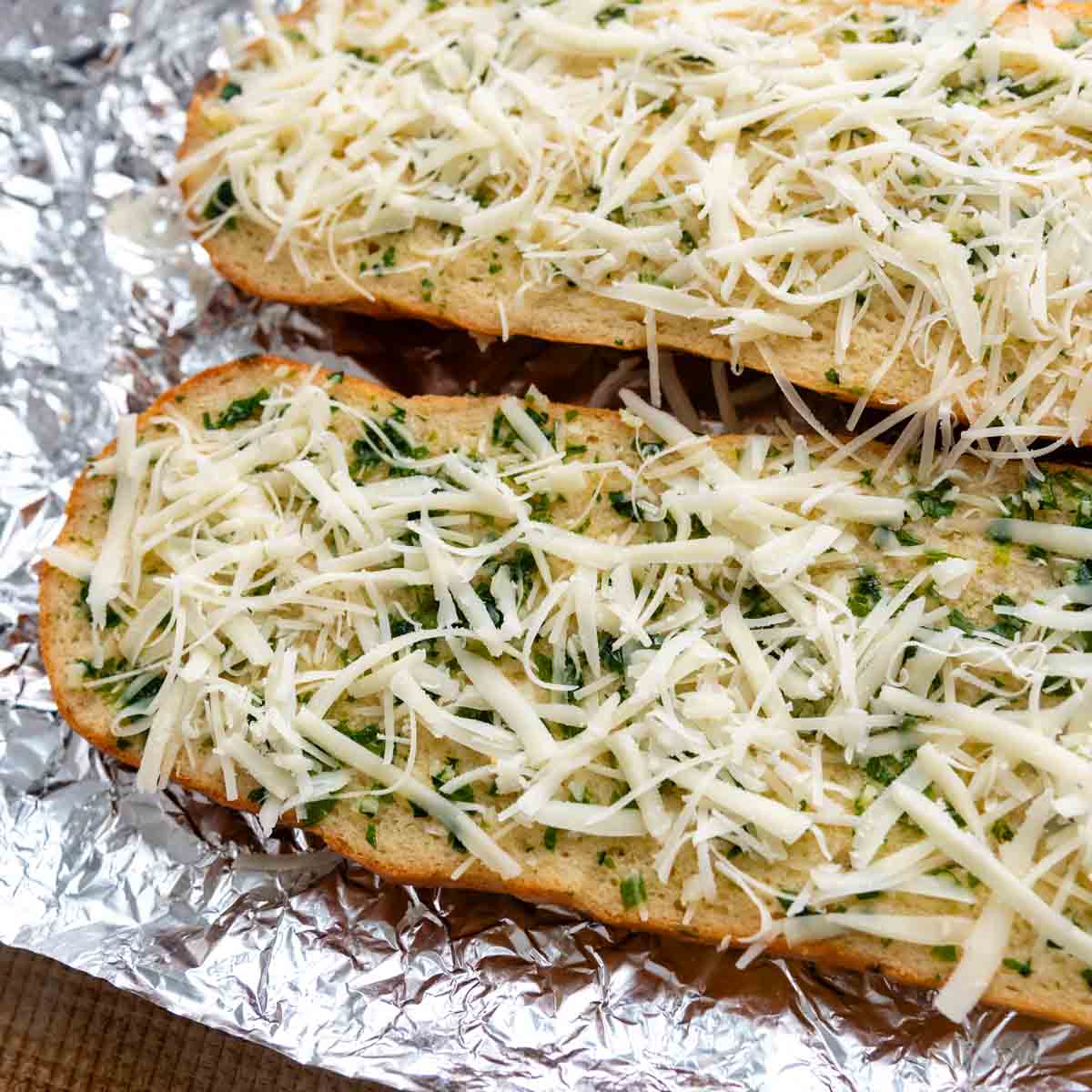 cut bread halves with cheese sprinkled on top before baking.
