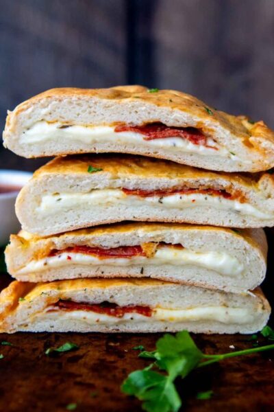 a stack of calzones sliced in half on top of each other.