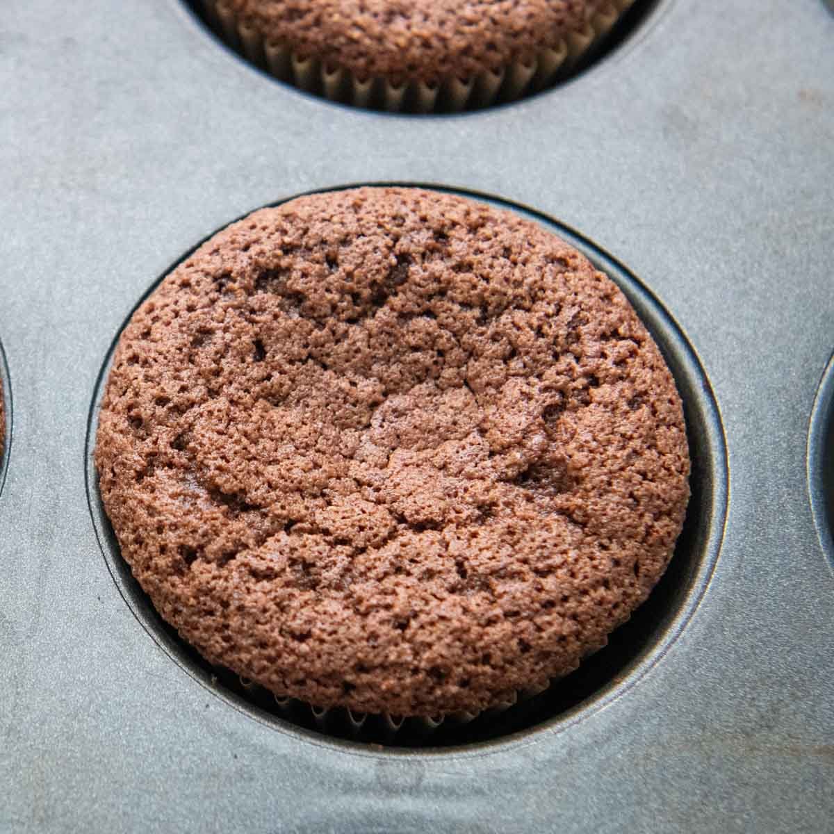 a baked cupcake in a muffin tin.