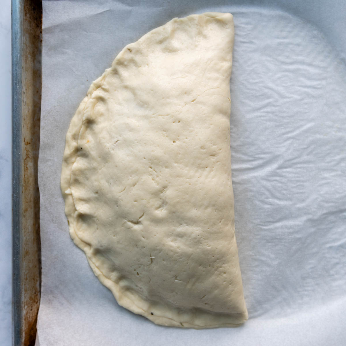 the calzone edges being shaped.