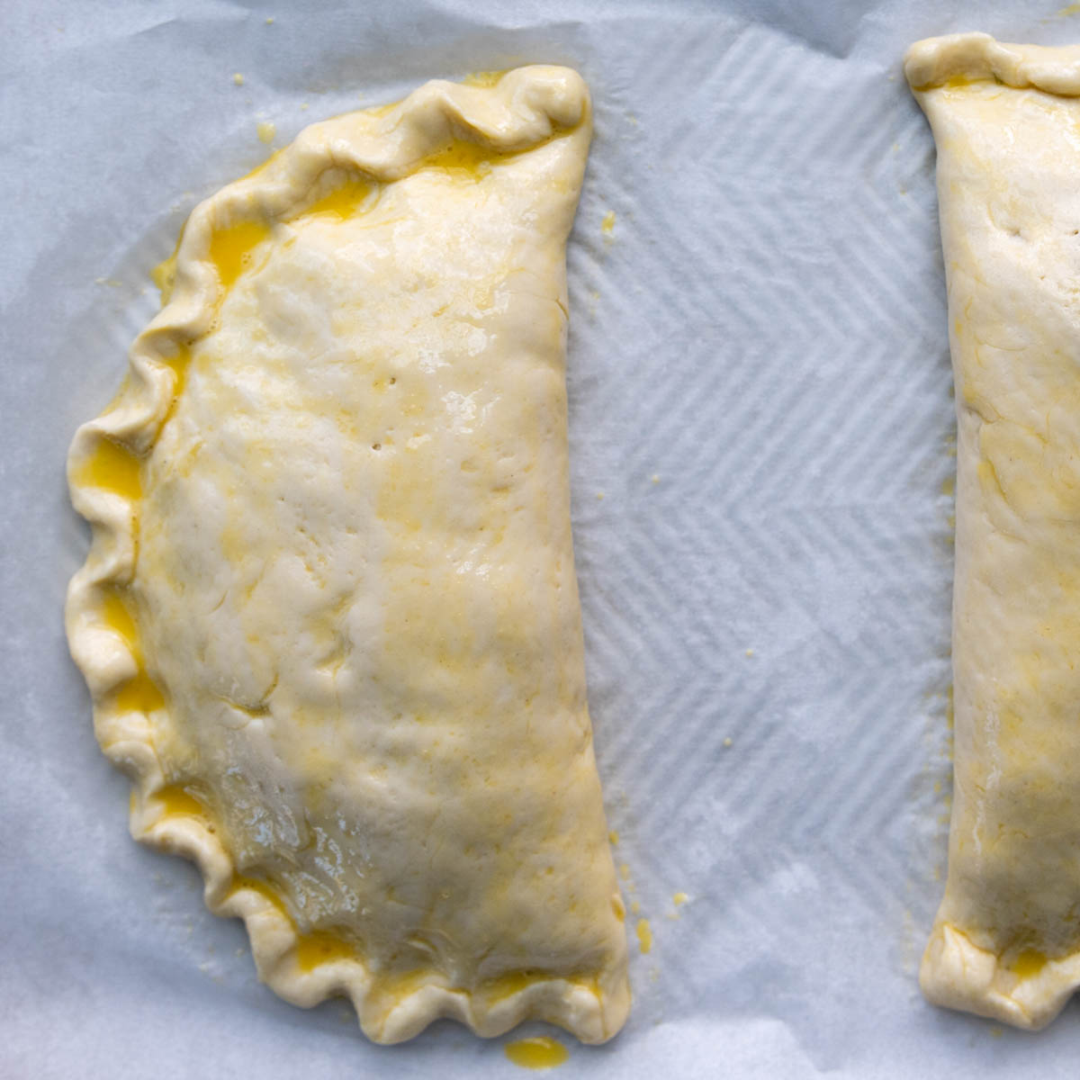 the unbaked calzones brushed with egg wash.