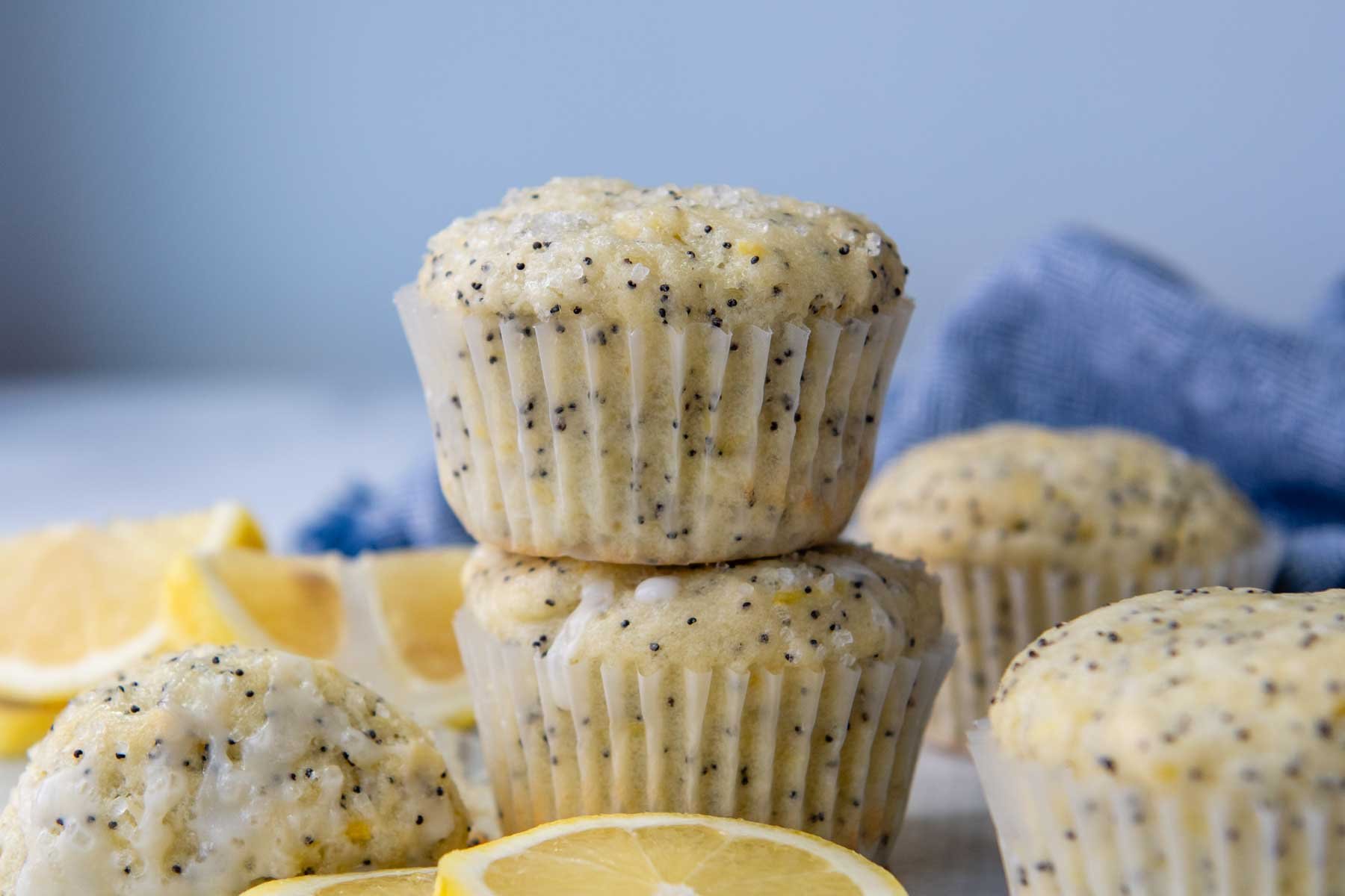 a stack of two muffins with lemon slices around.