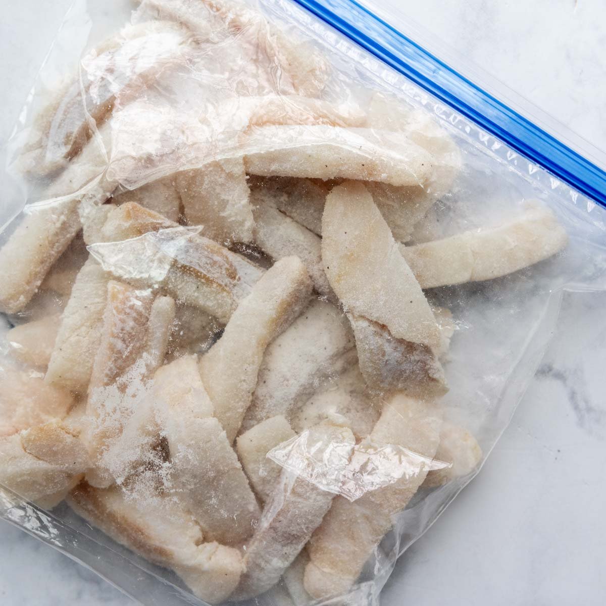 pieces of fish in a bag dredged with flour.