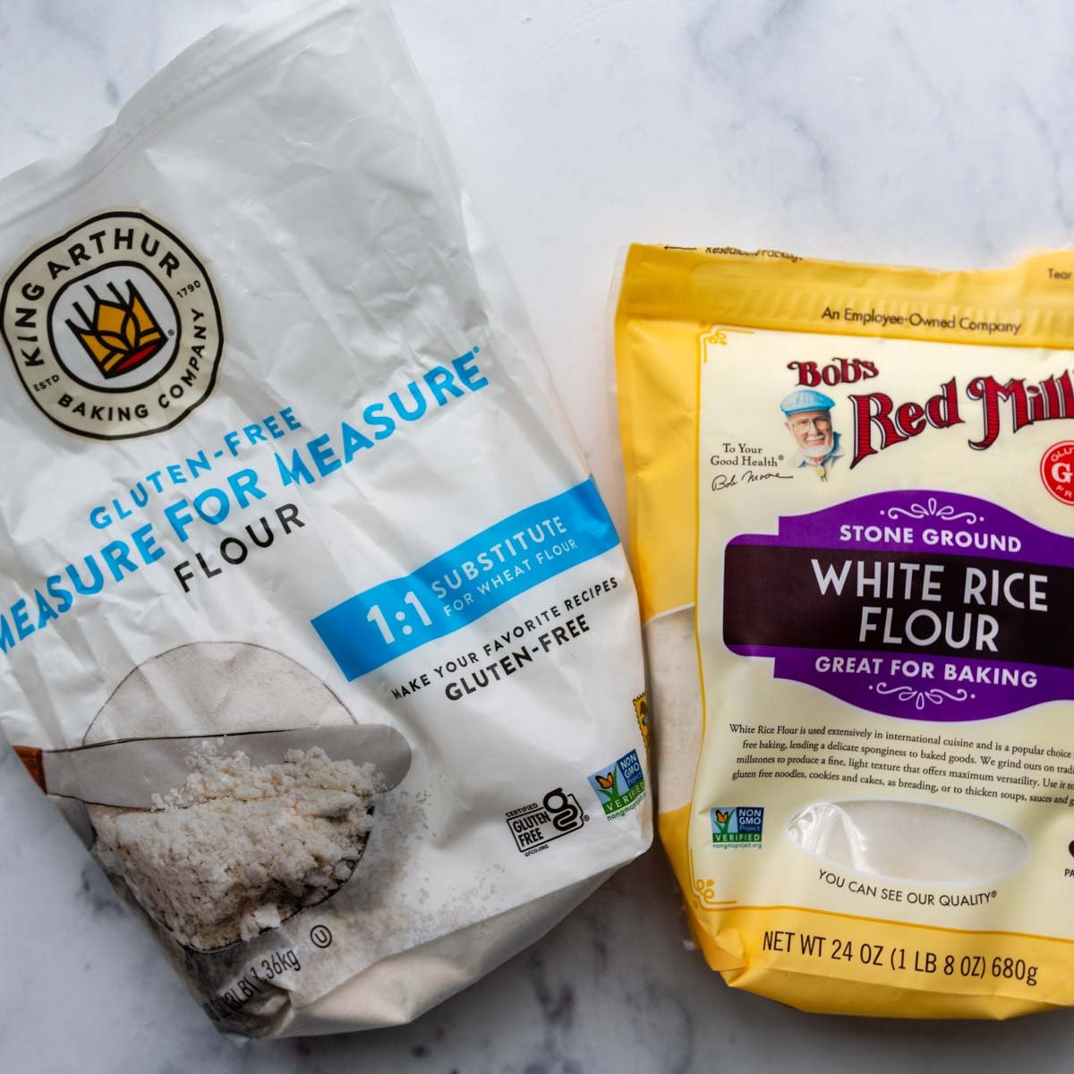king arthur flour and white rice flour on a marble surface.