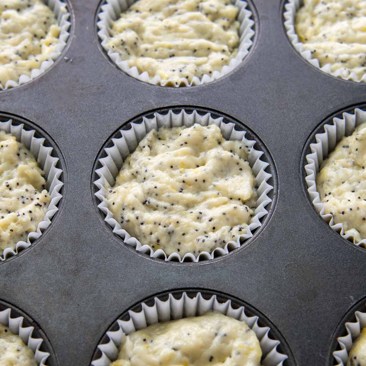 unbaked muffins in a muffin tin.