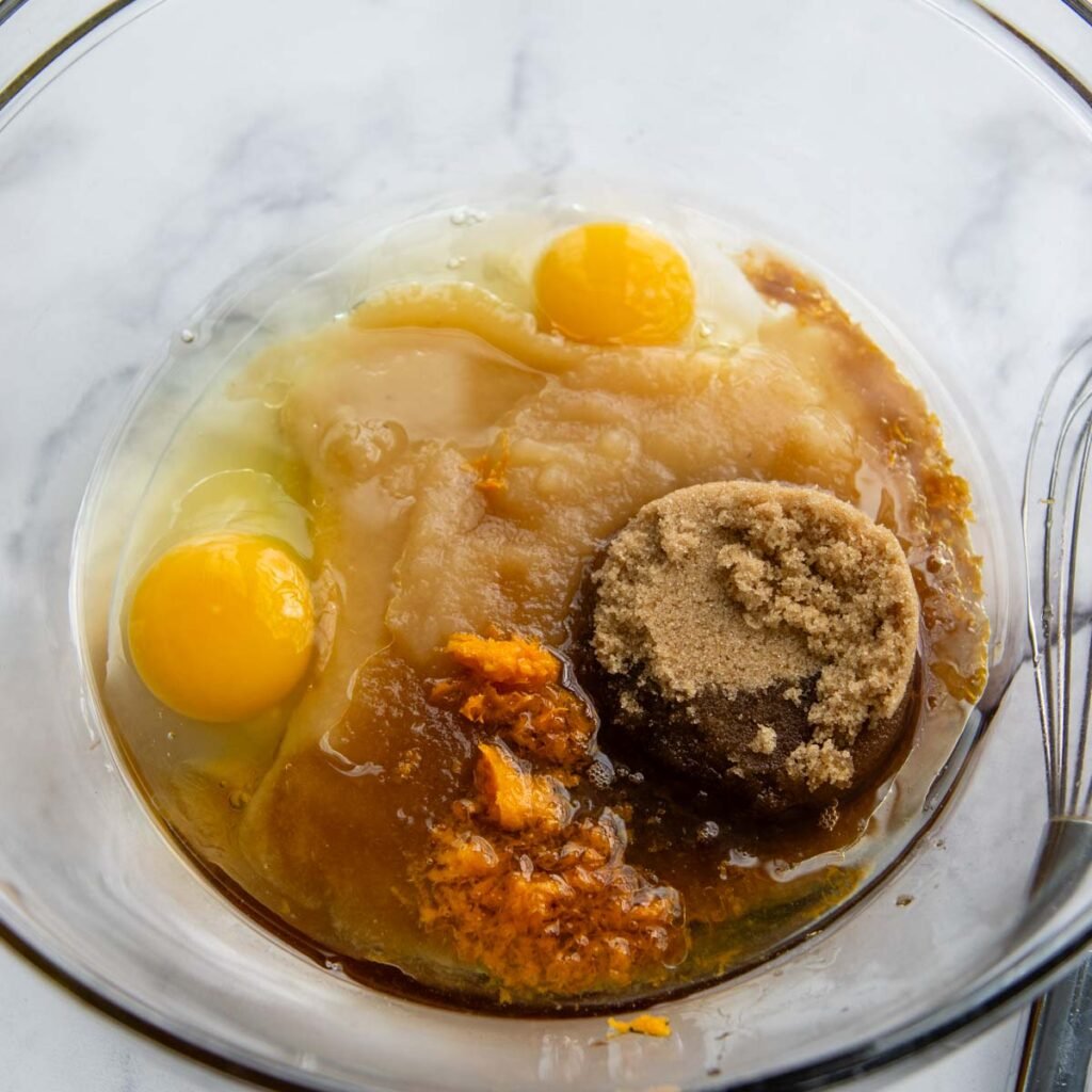 the eggs in a glass bowl with other wet ingredients.