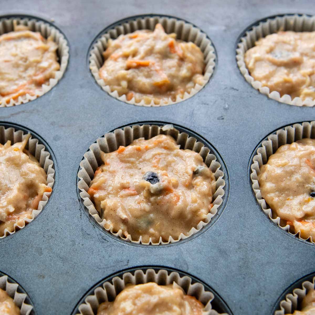 a muffin tin with filled with unbaked batter.