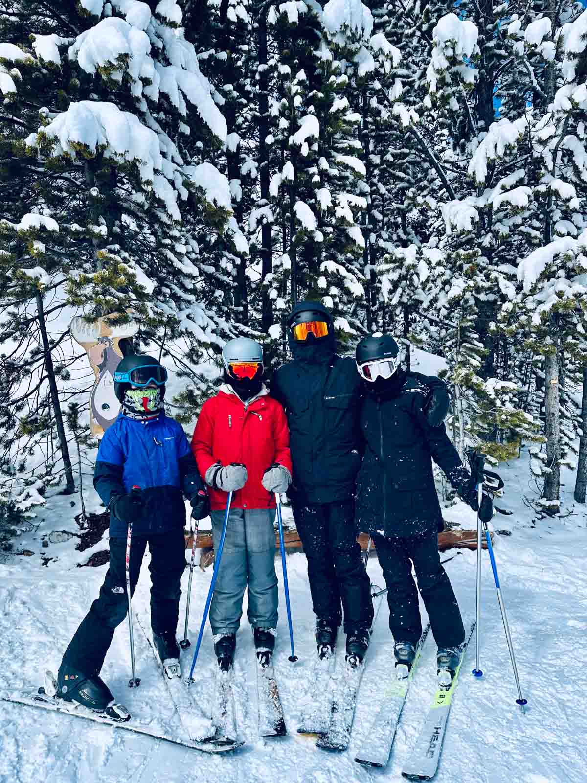 kids posing on a ski run.