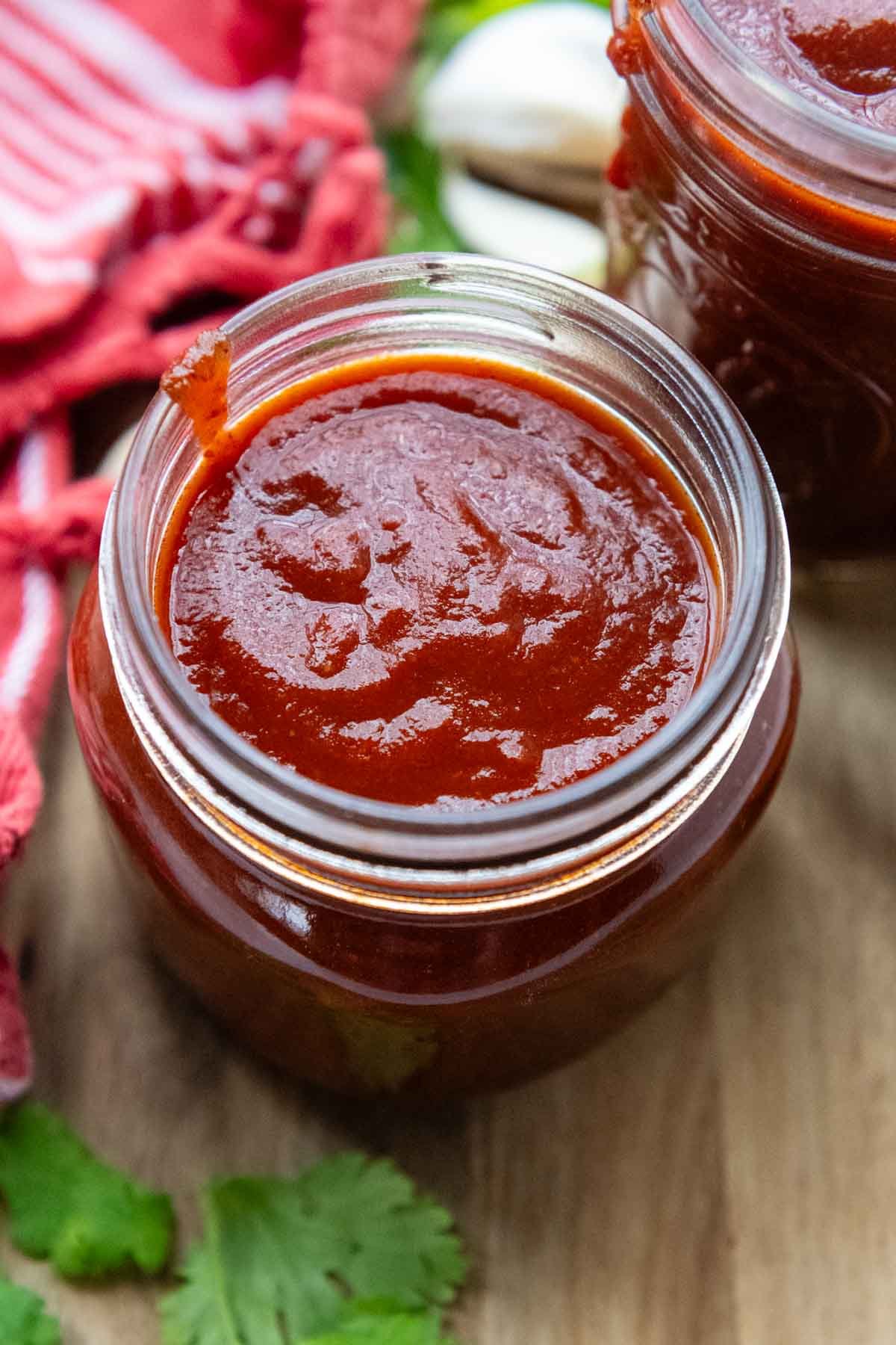 looking into the top of glass jar with enchilada sauce.