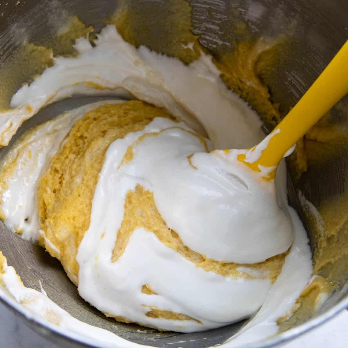 egg whites being folded into almond flour mixture.