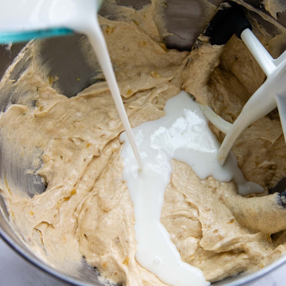 buttermilk being poured into the batter.