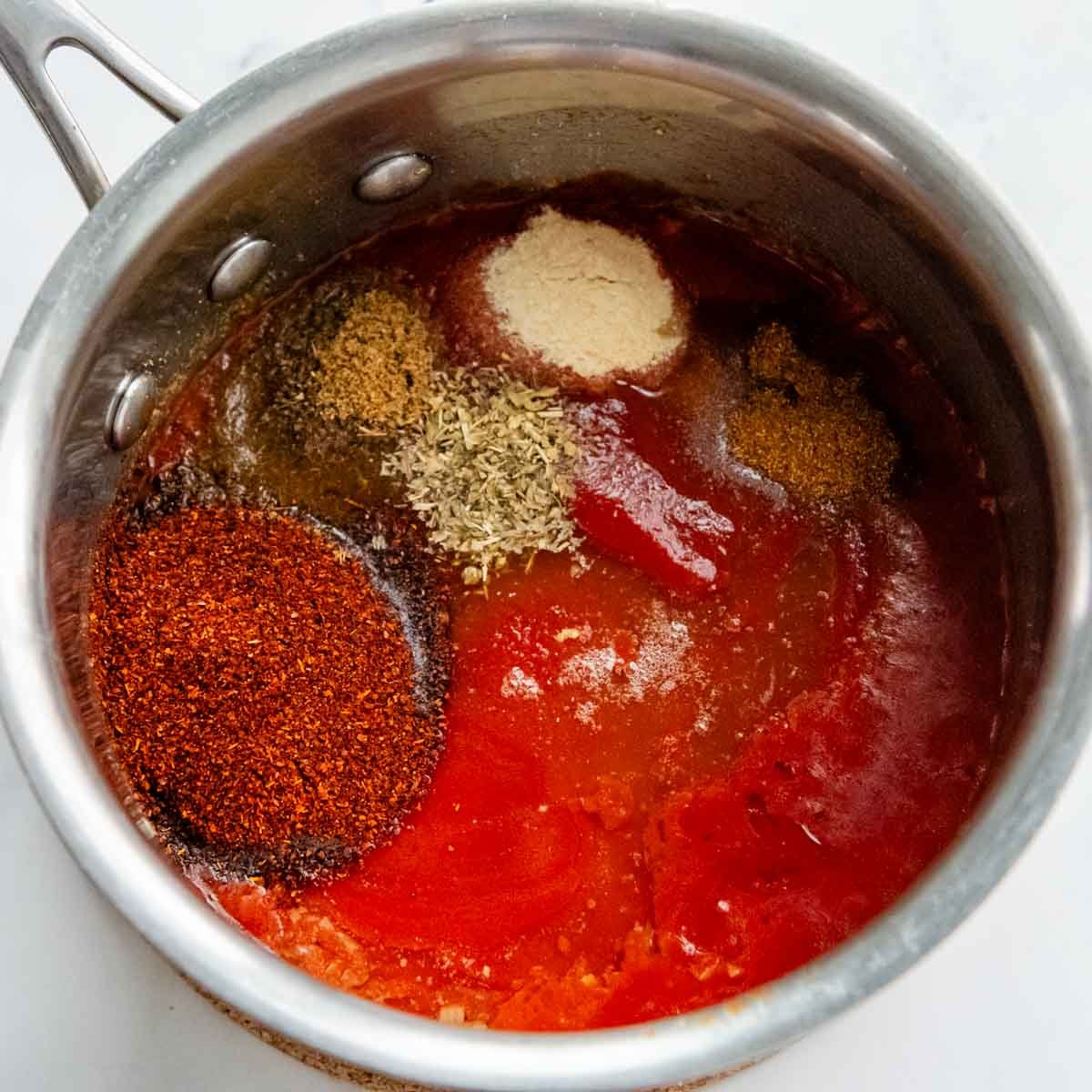 the tomato sauce and spices in a saucepan.
