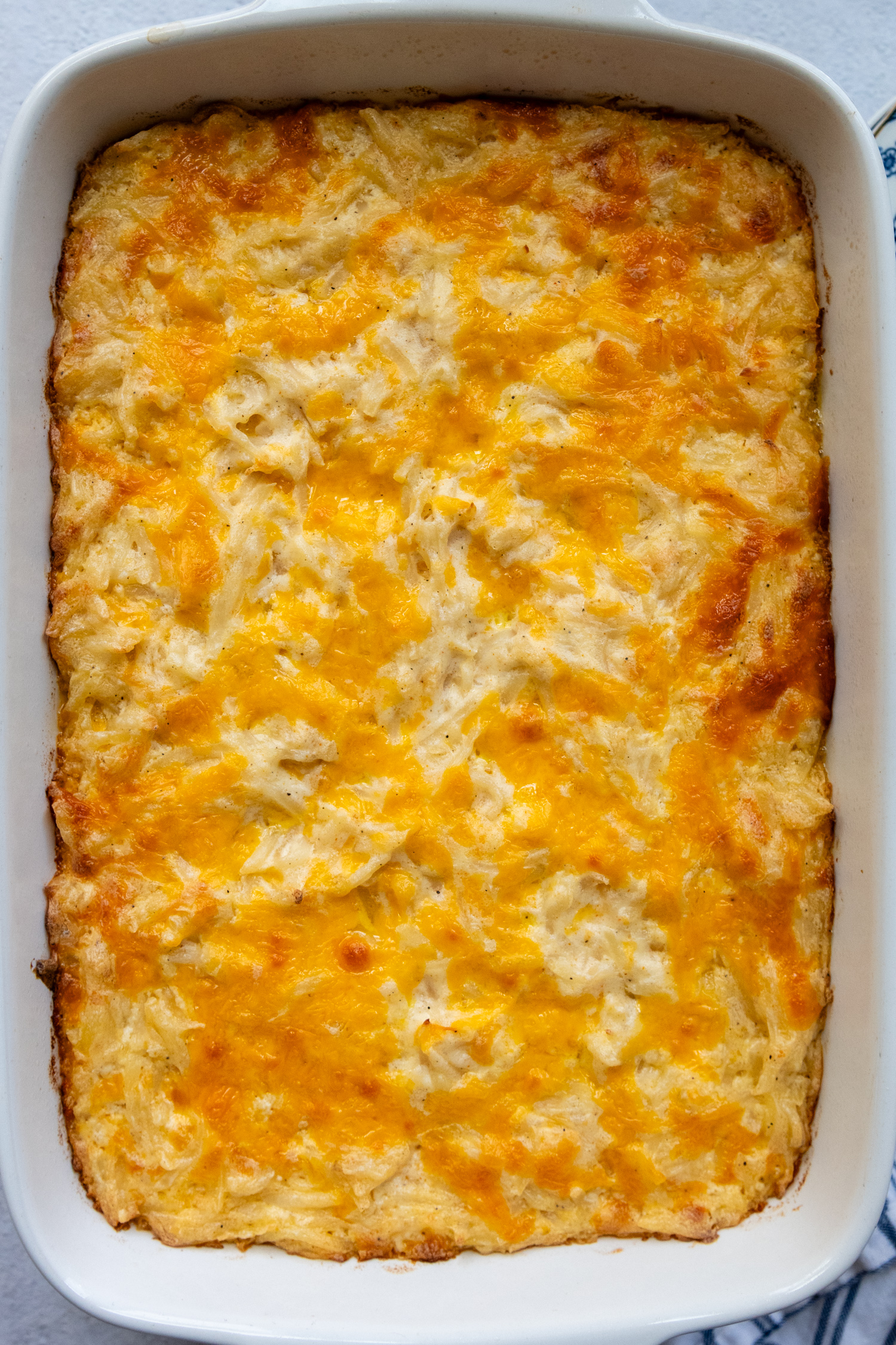 Overhead shot of casserole in a white baking dish showing all the cheese.