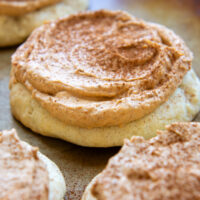 A Gluten-Free Pumpkin Cream Cookies frosted and sprinkled with cinnamon.
