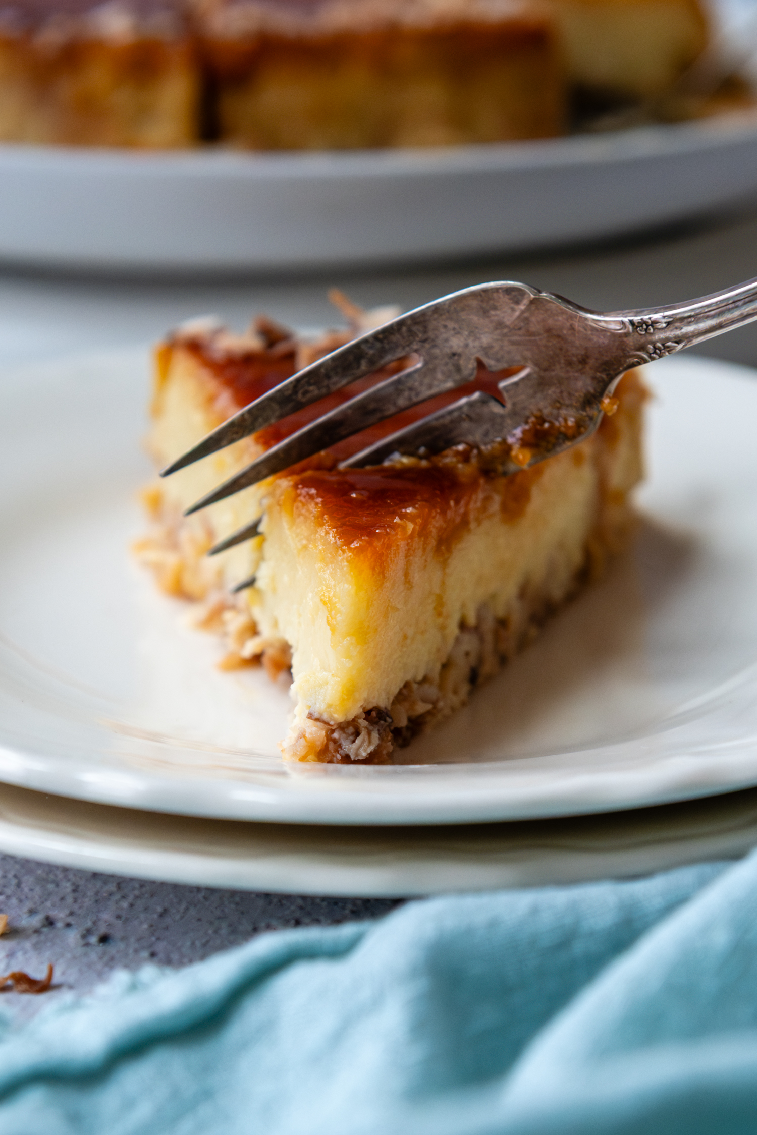 Fork cutting into a piece of flan.