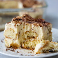 A slice of tiramisu with a bite taken out of it.