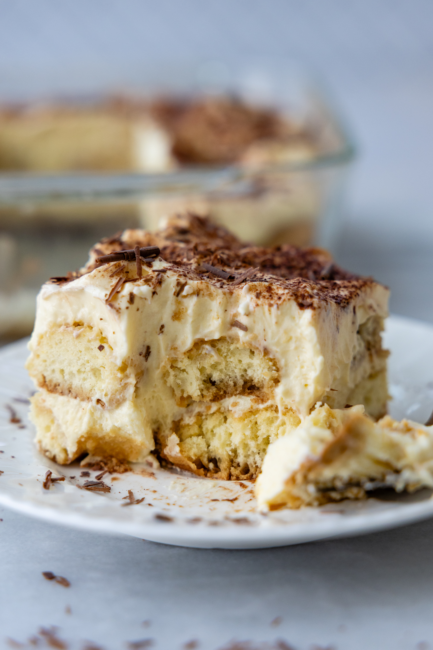 A slice of tiramisu with a bite taken out of it.