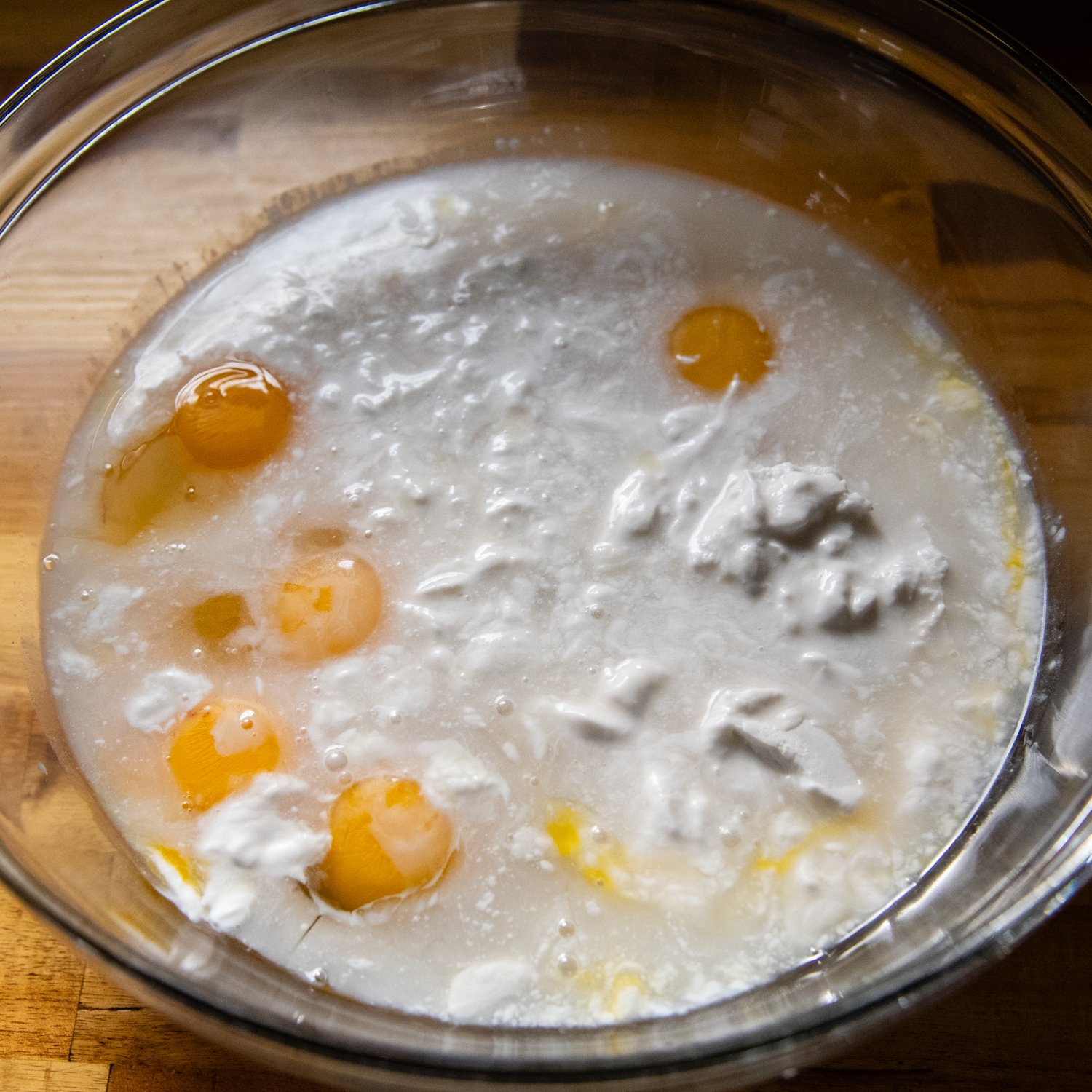 Liquid flan ingredients in a glass bowl.