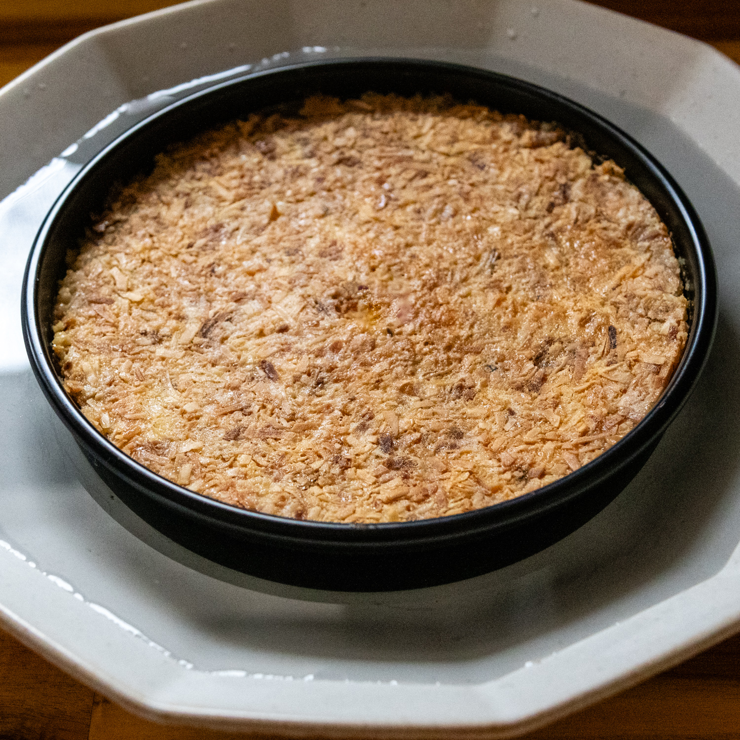 Flan in a pan in a large pan of hot water.