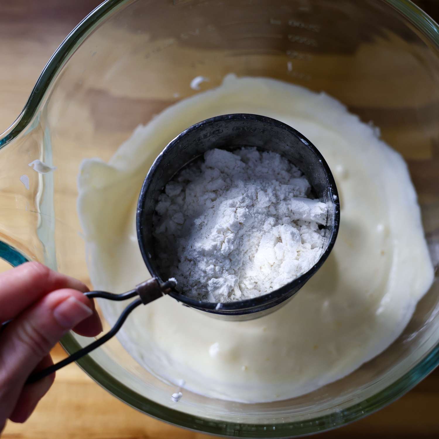 Sifting in backing powder and flour mixture.