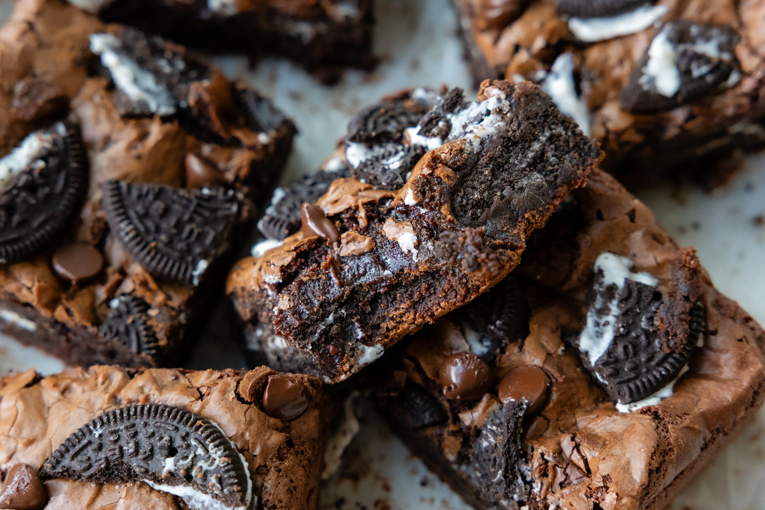 Brownie on top of other brownies with a bit taken out of it.