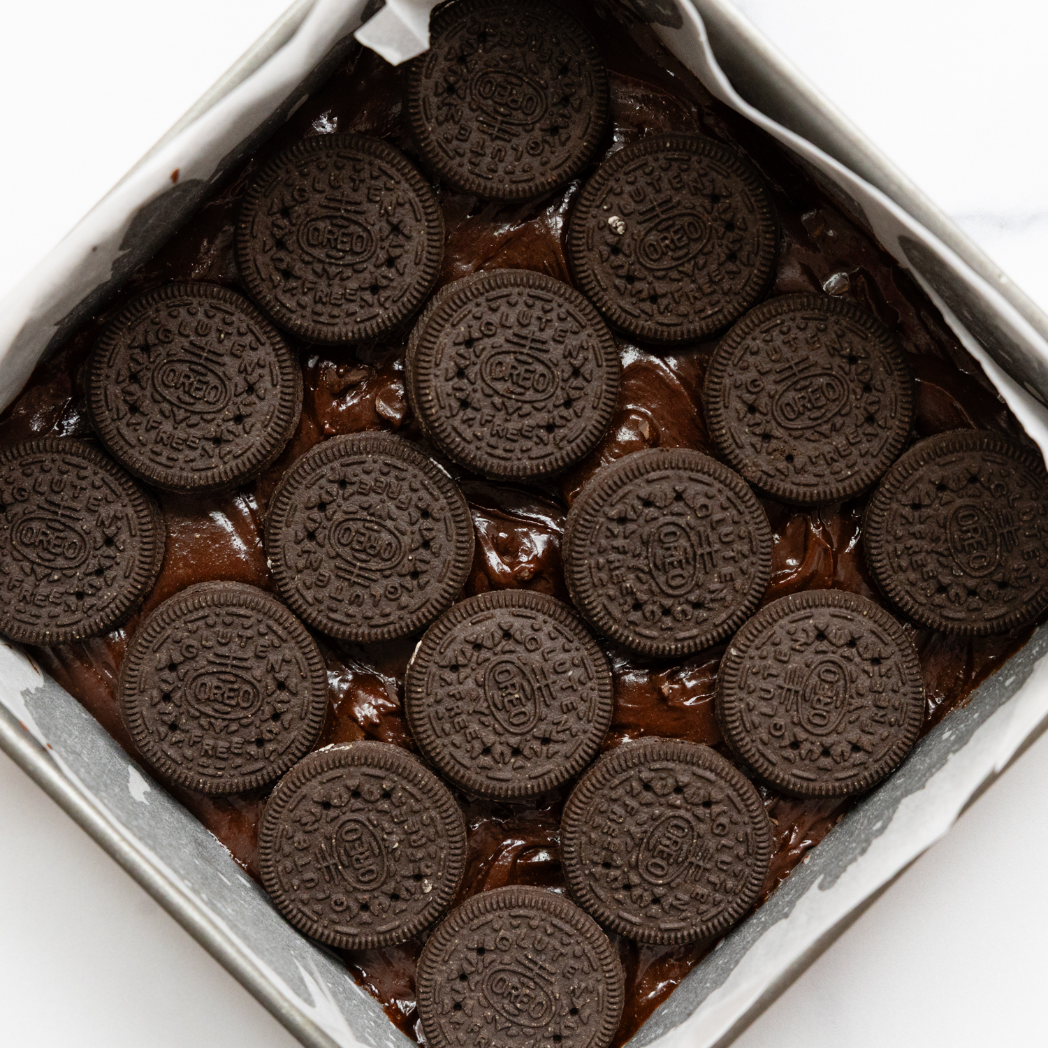 Gluten free Oreos laying in the bottom of a baking dish.
