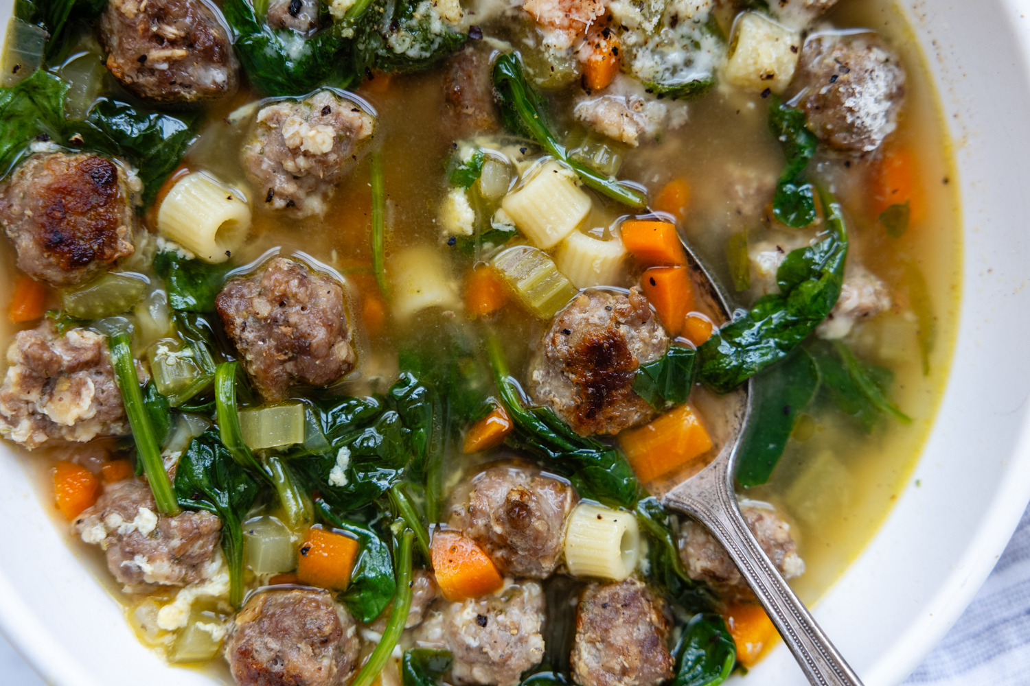 Soup in a white bowl with a spoon.