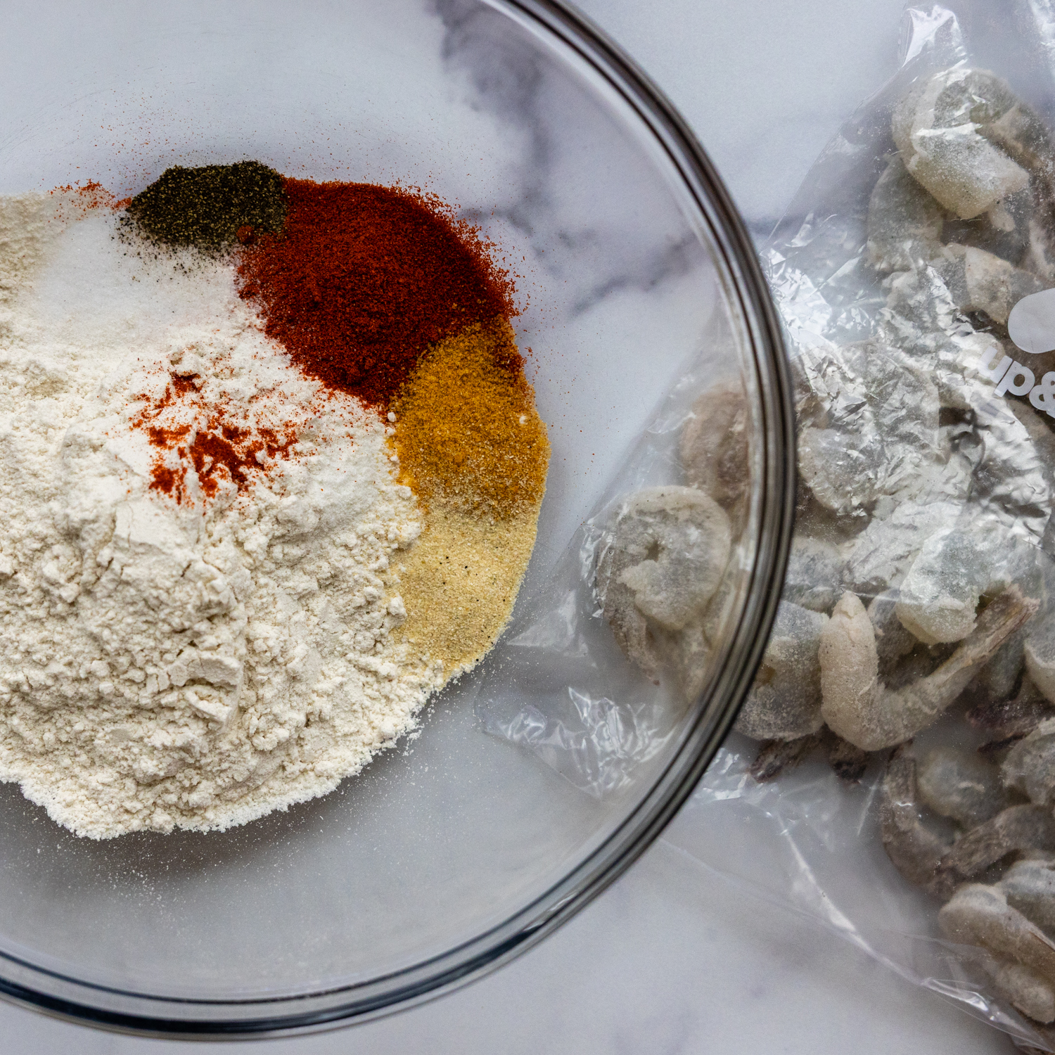 Dry batter ingredients in glass bowl.