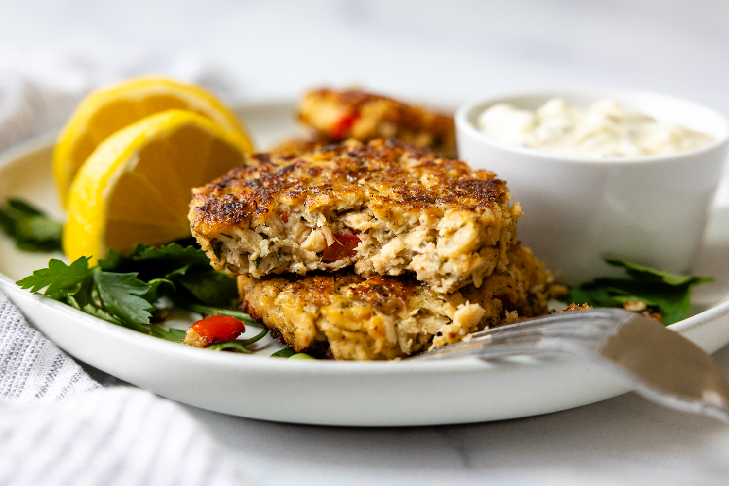Two salmon patties stack and cut open showing the inner texture of the patty.
