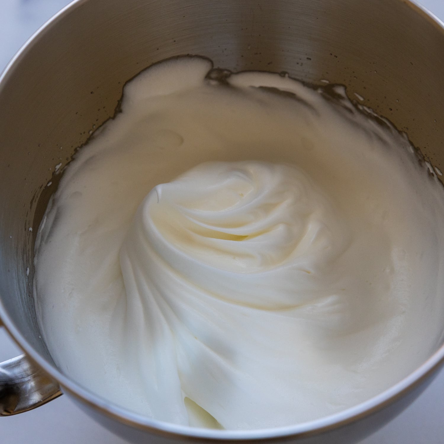 Foamy egg whites in a mixing bowl.