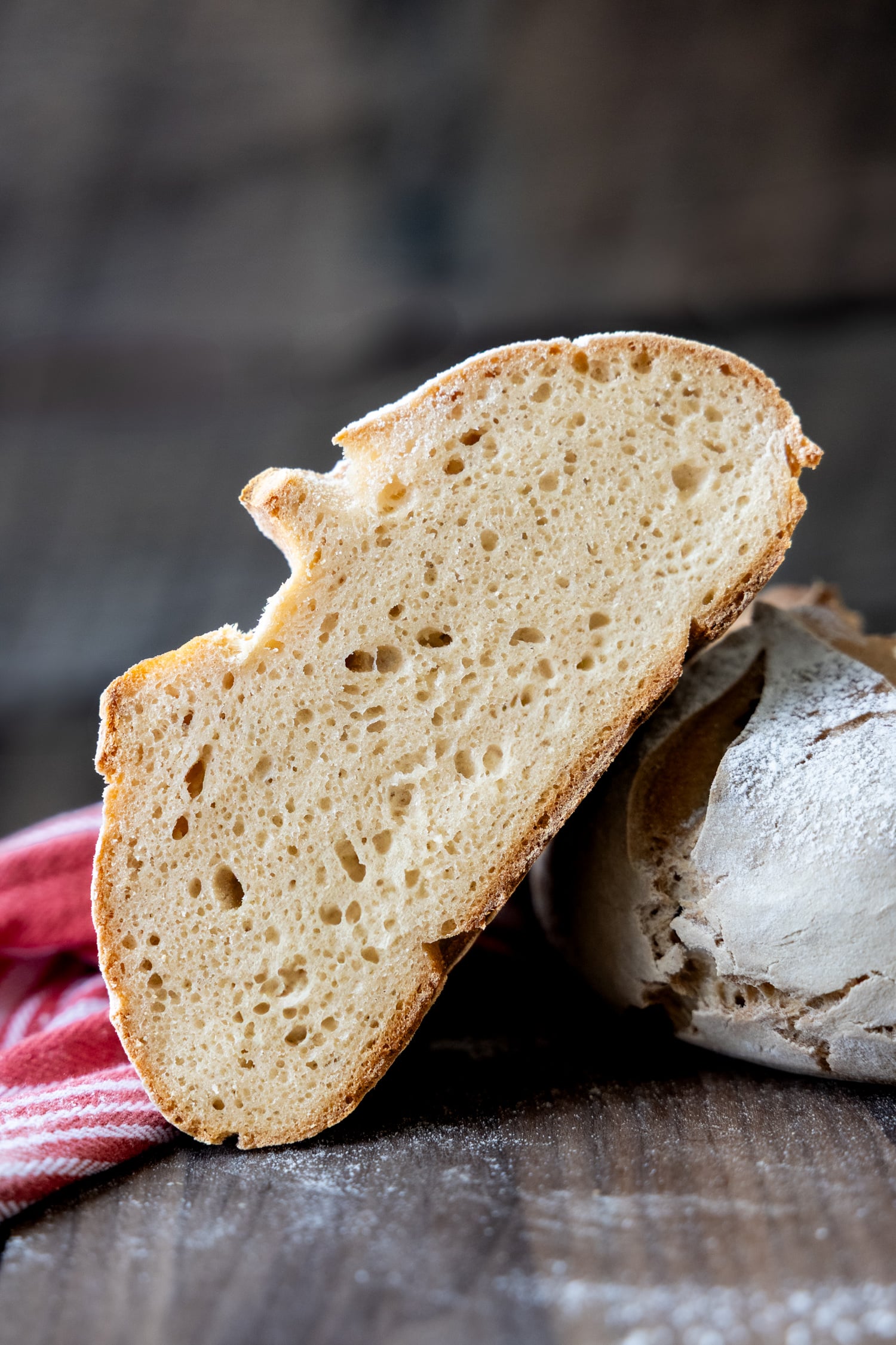 A slice of gluten free sourdough showing the inside texture.