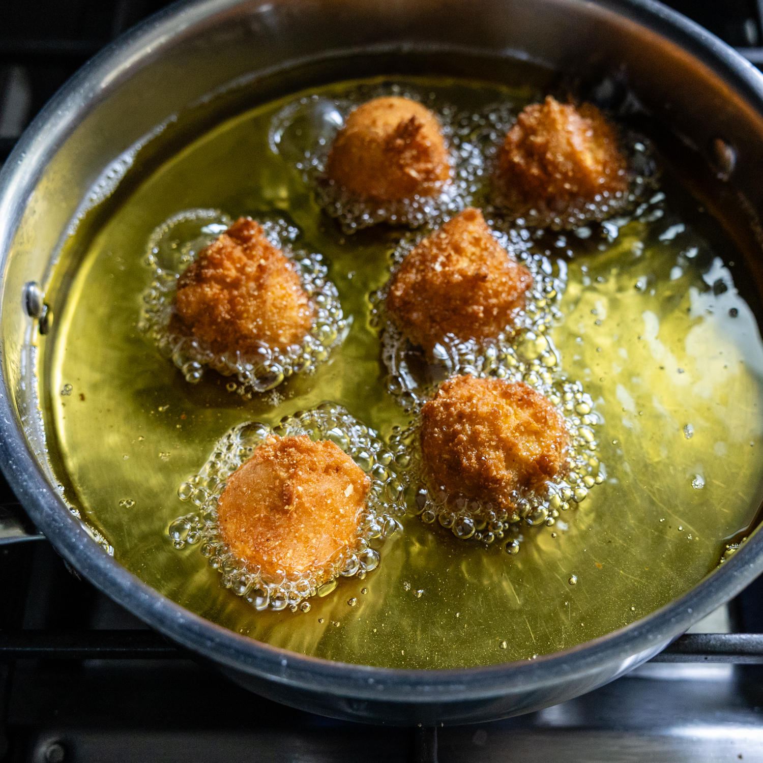 Hush puppy balls being fried.