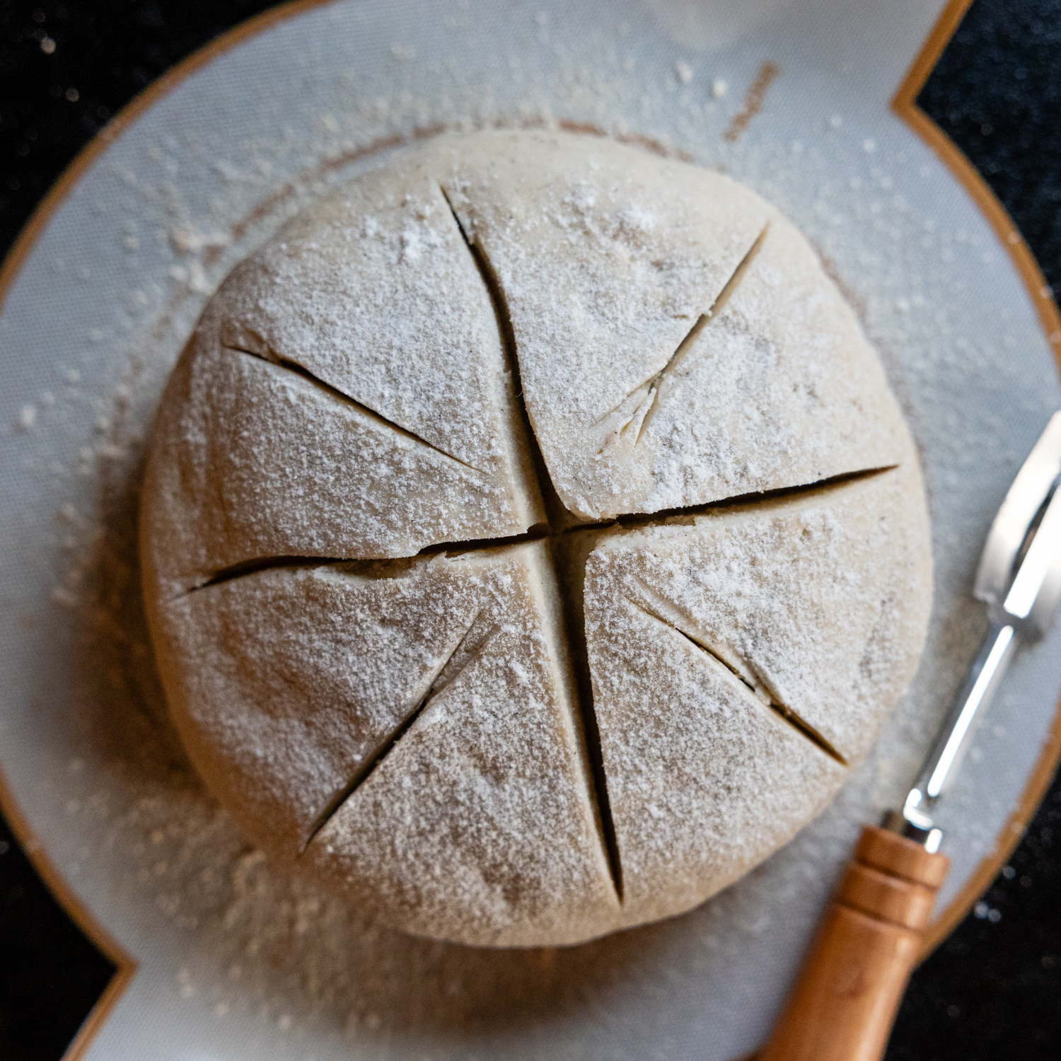 Overhead view of the deep cuts in the uncooked loaf.