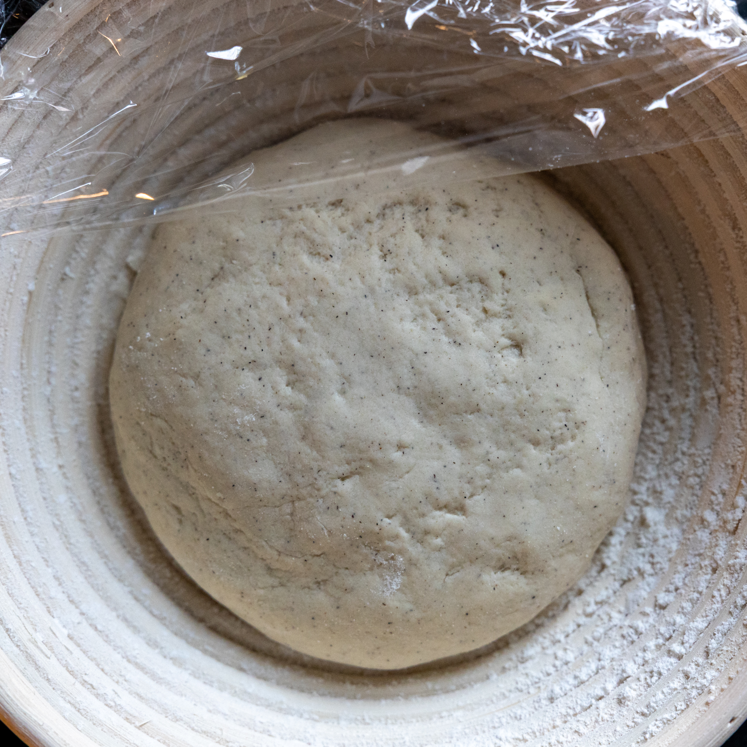 Sourdough loaf in bowl with wrap on top.