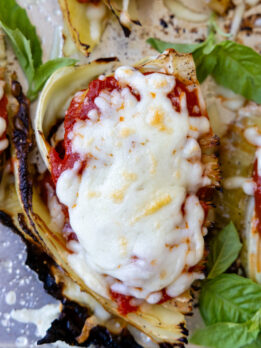 top view of cabbage parmesan with bubbly browned cheese on top.