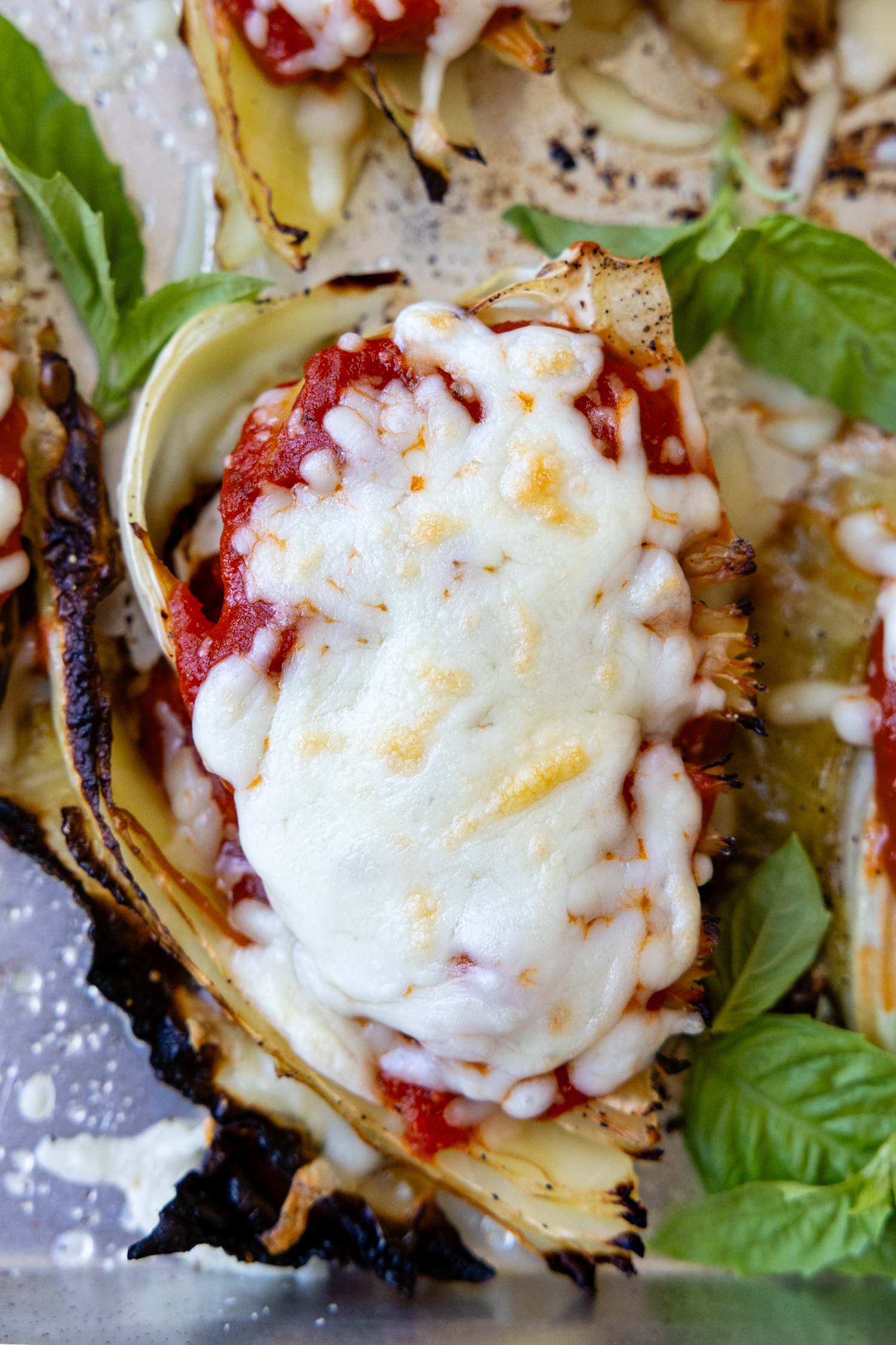top view of cabbage parmesan with bubbly browned cheese on top.