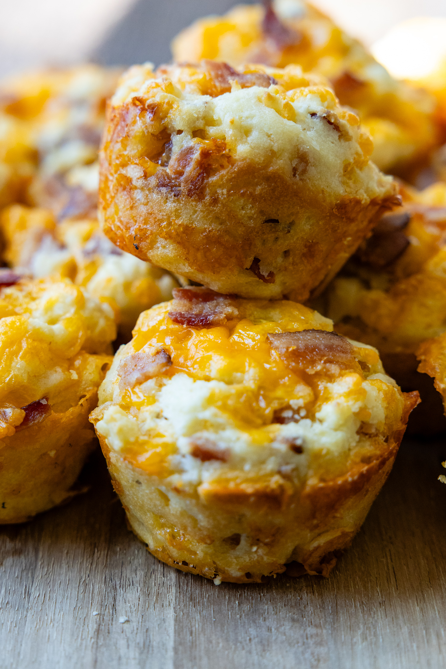 two savory muffins stacked on top of each other.